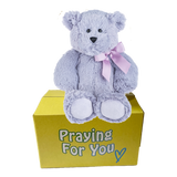 purple bear with matching ribbon tied in a bow sitting on a yellow box- send a prayer - send a plushie
